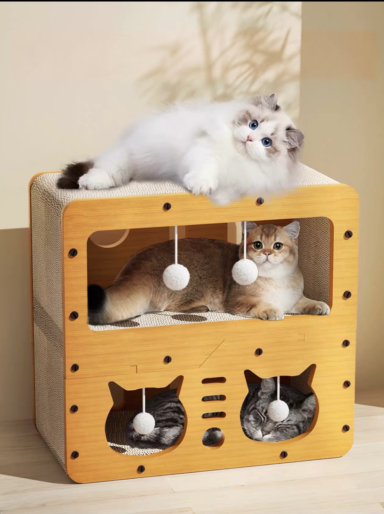 Two-tier indoor cat house with cats and hanging white toys